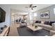 Inviting living room with hardwood floors, comfortable seating, and an open flow to the kitchen at 12964 Walbeck Dr, Fishers, IN 46037