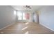 Bright living room with hardwood floors, neutral walls, ceiling fan, and large windows with blinds at 12964 Walbeck Dr, Fishers, IN 46037