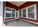 A charming patio with a rustic red wall, large windows, and access to the house at 12964 Walbeck Dr, Fishers, IN 46037