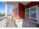 A cozy covered porch with red siding and white trim, perfect for relaxing outdoors at 12964 Walbeck Dr, Fishers, IN 46037
