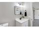 A renovated bathroom featuring white cabinets, updated lighting, and modern fixtures at 1818 Arlene Dr, Indianapolis, IN 46219