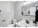 This updated bathroom has white cabinets, updated hardware, and a modern mirror at 1818 Arlene Dr, Indianapolis, IN 46219