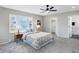 This bedroom has plush gray carpeting, a ceiling fan, and a bright sunny window at 1818 Arlene Dr, Indianapolis, IN 46219