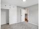 A cozy bedroom with gray walls, carpet, and white trim, including built-in storage above the closet at 1818 Arlene Dr, Indianapolis, IN 46219