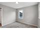 A bright bedroom features a window, gray walls, neutral carpet and clean, white trim at 1818 Arlene Dr, Indianapolis, IN 46219
