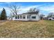 Side view of a single-story home featuring vinyl siding, an attached garage, and a well-maintained lawn at 1818 Arlene Dr, Indianapolis, IN 46219