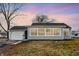 Charming single-story home with a light blue exterior, attached garage, and large picture window at 1818 Arlene Dr, Indianapolis, IN 46219