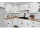 Updated kitchen with white cabinets, butcher block countertops, black hardware, and stainless steel appliances at 1818 Arlene Dr, Indianapolis, IN 46219
