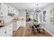 Modern kitchen with white cabinets, a black sink, butcher block countertops, and stainless steel appliances at 1818 Arlene Dr, Indianapolis, IN 46219