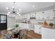 Updated kitchen with white cabinets, butcher block countertops, and stainless steel appliances adjacent to dining area at 1818 Arlene Dr, Indianapolis, IN 46219