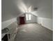 The attic area showcases neutral paint, new carpeting, and a functional red display cabinet at 1905 Apple St, Greenfield, IN 46140
