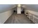 The attic area showcases neutral paint, new carpeting, and a practical closet at 1905 Apple St, Greenfield, IN 46140