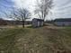 Spacious backyard featuring a shed, mature trees and a swing at 1905 Apple St, Greenfield, IN 46140