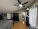Upper level bedroom with a TV, fan, and carpet at 1905 Apple St, Greenfield, IN 46140