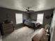 Comfortable bedroom with carpet flooring and natural light from two large windows at 1905 Apple St, Greenfield, IN 46140