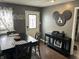 Cozy dining room with black dining set, hardwood floors, and Mickey Mouse decor at 1905 Apple St, Greenfield, IN 46140
