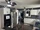 Bright kitchen with stainless steel appliances, white cabinetry, and fan with light at 1905 Apple St, Greenfield, IN 46140