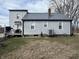 Rear exterior view of the house, highlighting the siding, updated windows, and well-manicured lawn at 1905 Apple St, Greenfield, IN 46140