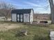 Backyard shed with unique door design and secure fenced area at 1905 Apple St, Greenfield, IN 46140