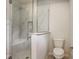 Modern bathroom with a glass shower, a marble-like design, and a comfortable toilet at 206 N Hamilton Ave, Indianapolis, IN 46201