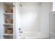 Close-up of a tub/shower featuring white subway tile and built-in storage shelves at 206 N Hamilton Ave, Indianapolis, IN 46201