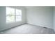 Bright, airy bedroom with a large window, neutral-toned walls, and plush carpeting at 206 N Hamilton Ave, Indianapolis, IN 46201