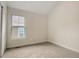 Cozy bedroom featuring plush carpet, a bright window, and neutral-toned walls at 206 N Hamilton Ave, Indianapolis, IN 46201