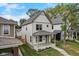 Angle view of the home featuring a covered front porch, landscaping, and an inviting facade at 206 N Hamilton Ave, Indianapolis, IN 46201