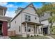 Shot of the home's exterior with a covered front porch, neat landscaping, and a welcoming facade at 206 N Hamilton Ave, Indianapolis, IN 46201