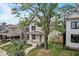 View of home with a covered front porch, landscaped yard, and a mature tree at 206 N Hamilton Ave, Indianapolis, IN 46201