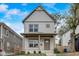 Charming two-story home featuring a quaint front porch and beautifully landscaped yard at 206 N Hamilton Ave, Indianapolis, IN 46201