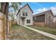 Charming two-story home with a manicured front yard, sidewalk and light-colored siding at 206 N Hamilton Ave, Indianapolis, IN 46201