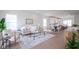 Open-concept living room with neutral tones, hardwood floors, and a view into the kitchen at 206 N Hamilton Ave, Indianapolis, IN 46201