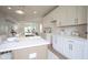 Modern kitchen boasts white cabinets, quartz countertops, and stainless steel appliances at 206 N Hamilton Ave, Indianapolis, IN 46201