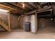 Unfinished basement with water heater, stairs, and concrete floor at 2110 N Talbott St, Indianapolis, IN 46202