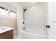 Modern bathroom with a shower and tub featuring white marble-style tile and a black shower head at 2110 N Talbott St, Indianapolis, IN 46202