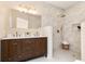 Primary bathroom showcasing a double vanity and large walk-in shower with beautiful marble-style tiling at 2110 N Talbott St, Indianapolis, IN 46202