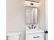 The bathroom features a modern vanity, mirror, and fixtures with a toilet at 2110 N Talbott St, Indianapolis, IN 46202