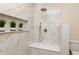Bathroom features shower with marble-style tile, built-in shelves, bronze fixtures, and a corner shower seat at 2110 N Talbott St, Indianapolis, IN 46202