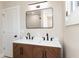 Bathroom featuring double sink vanity with modern fixtures, a large mirror, and a partial view of the shower at 2110 N Talbott St, Indianapolis, IN 46202