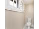 Powder room features a standard toilet, a white wall and marble-style floors, and a small window for light at 2110 N Talbott St, Indianapolis, IN 46202