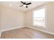 Bright bedroom featuring a large window, neutral walls, ceiling fan, and light hardwood floors at 2110 N Talbott St, Indianapolis, IN 46202