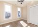 Neutral bedroom featuring two large windows and light hardwood floors at 2110 N Talbott St, Indianapolis, IN 46202