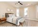 Cozy bedroom featuring a ceiling fan, two windows, neutral walls, and warm-toned wood floors at 2110 N Talbott St, Indianapolis, IN 46202