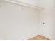 Bright and airy closet space with a simple rod and shelf storage solution and painted wood walls at 2110 N Talbott St, Indianapolis, IN 46202