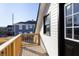 New wooden deck with railing, offering outdoor space and light, adjacent to a black-trimmed window at 2110 N Talbott St, Indianapolis, IN 46202