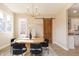 Bright dining room featuring hardwood floors, a modern chandelier, and a unique sliding barn door at 2110 N Talbott St, Indianapolis, IN 46202