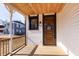 Cozy front porch with wood ceiling leads to the beautiful paneled front door at 2110 N Talbott St, Indianapolis, IN 46202