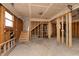 Unfinished garage featuring stairs and exposed framing at 2110 N Talbott St, Indianapolis, IN 46202
