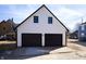 Two car garage with white siding, dark trim, and a gabled roof, offering ample parking at 2110 N Talbott St, Indianapolis, IN 46202